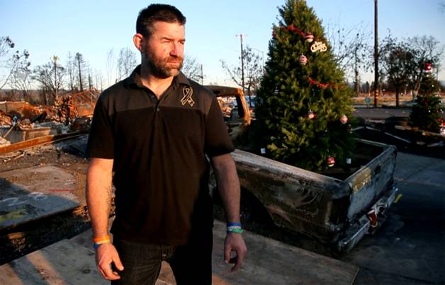 Former Coffey Park resident Ronnie Duvall surveys Christmas decorations being added to the fire-scarred neighborhood, Tuesday, Dec. 12, 2017. The community was estroyed two months ago when the Wine Country firestorm swept through Santa Rosa, Calif. (Karl Mondon/Bay Area News Group)
