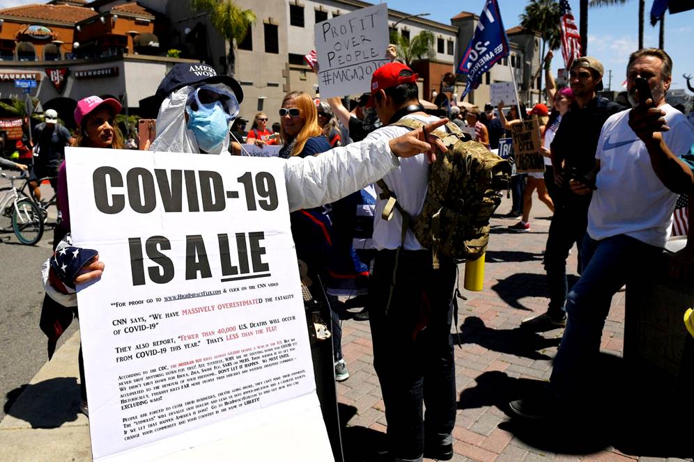 Protesters demonstrate against stay-at-home orders that were put in place due to the COVID-19 outbreak, Friday, April 17, 2020, in Huntington Beach, Calif. (AP Photo/Mark J. Terrill) ORG XMIT: CAMT117