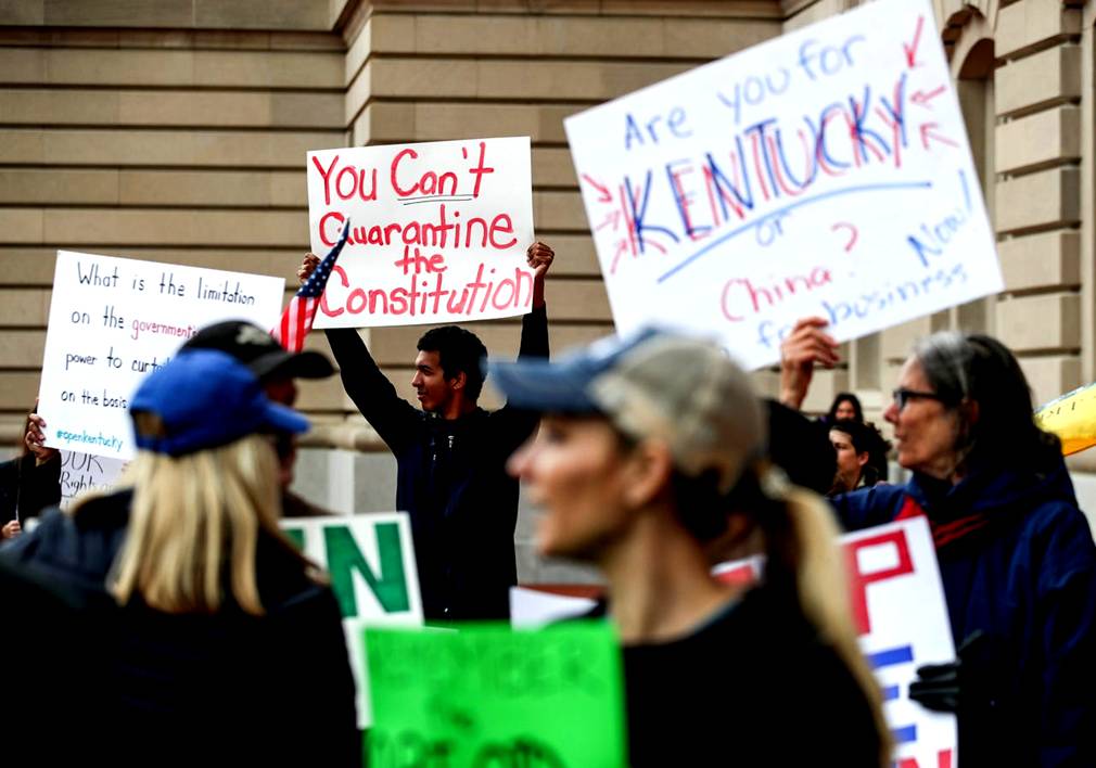 Protestors yell 'Open Up Kentucky' and 'You're not a king. We won't kiss your ring' outside the the state capitol on April 15, 2020 in Frankfort, Ky. where Gov. Andy Beshear was giving his daily Coronavirus updates.