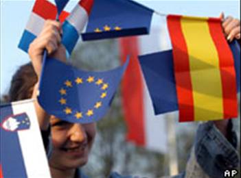 A Polish girl waves EU flags during an EU enlargement party in Zittau