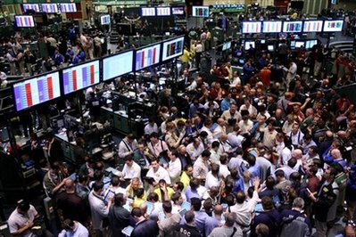 Traders work on the floor of the New York Mercantile Exchange ...