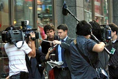 A man is surrounded by reporters as he arrives at the Lehman ...
