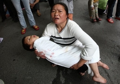 A Chinese woman tries to evacuate her son from a hospital in ...