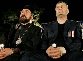 South Ossetian leader Eduard Kokoity, right, and a priest hold ...
