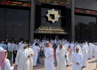 Kuwaiti investors gather outside the Kuwait Stock Exchange in ...