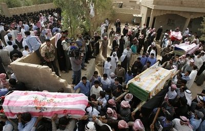 Syrian villagers carry the coffins of relatives who died a day ...