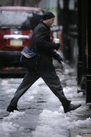 A person steps over a slush puddle on Market street in Philadelphia, Monday, April 16, 2007.
 Matt Rourke -- AP Photo