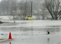 A yellow car, abandoned by its driver, sits stalled in water that overflowed the banks of the Cooper River Sunday, April 15, 2007, along South Park Drive in Collingswood, N.J.
 Tom Mihalek -- AP Photo