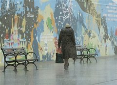 A pedestrian makes his way by a mural for the New York Aquarium at Coney Island in New York, Sunday, April 15, 2007 as a nor'easter storm blows through the area. The storm is expected to dump as much as five inches of rain on the area in the next 36 hours.
 Kathy Willens -- AP Photo