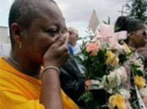 Sabrina Mays-Montana covers her mouth during a memorial ceremony for victims of Hurricane Katrina and Rita. (Reuters)