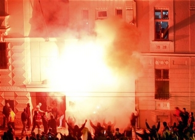 The U.S. embassy in Belgrade burns after masked attackers broke ...