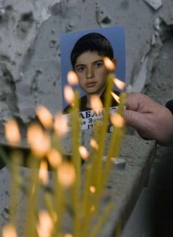 A photo of a boy, who died in the 2004 hostage crisis, is seen ...