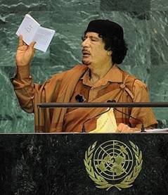Libyan leader Colonel Moamer Kadhafi holds a copy of the UN ...