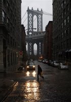A woman crosses a rain-slicked street near the waterfront in the Brooklyn borough of New York on Sunday, April 15, 2007.
 Peter Morgan -- AP Photo